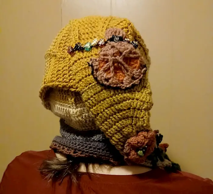 OOAK handmade crochet elf hat back view with textured stitches, floral detail, and decorative bead accents