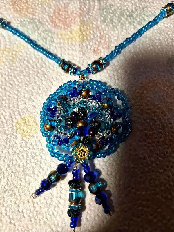 Shield against the fear of failure. A handmade pendant necklace by Artisan Regina L.